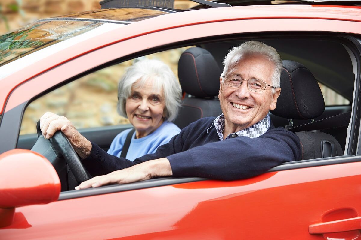 Lachendes älteres Paar im Auto